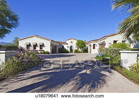 Stock Image - View up the driveway of luxury villa.. Fotosearch