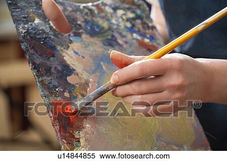 Stock Photography - Woman hand close up painting. Fotosearch