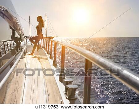 Stock Image - Woman on Deck of Boat. Fotosearch