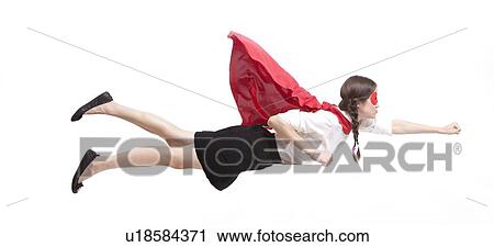 Stock Image - Young Asian woman in superhero costume in flying pose against white background. Fotosearch