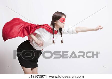 Stock Image - Young Asian woman pretending to be a superhero against white background. Fotosearch