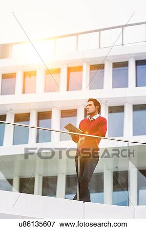 Young attractive businessman using digital tablet View Large Photo Image Stock Photo - Young attractive businessman using digital tablet. Fotosearch