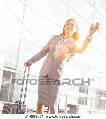 Young attractive businesswoman calling for taxi in airport View Large Photo Image Stock Image - Young attractive businesswoman calling for taxi in airport. Fotosearch