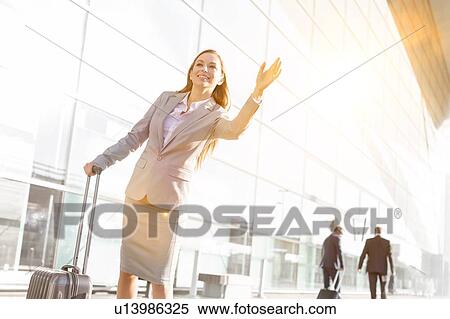 Young attractive businesswoman calling for taxi in airport View Large Photo Image Stock Photography - Young attractive businesswoman calling for taxi in airport. Fotosearch