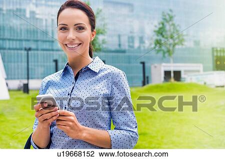 Young attractive businesswoman using smartphone outdoors View Large Photo Image Stock Image - Young attractive businesswoman using smartphone outdoors. Fotosearch