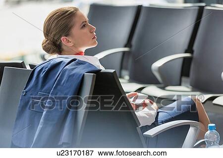 Young attractive businesswoman using smartphone while waiting for her flight in airport View Large Photo Image Stock Photo - Young attractive businesswoman using smartphone while waiting for her flight in airport. Fotosearch