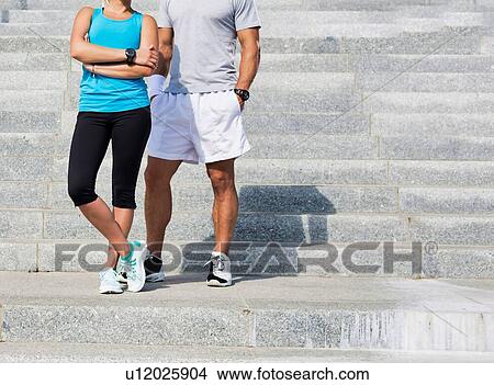 Picture - Young attractive couple exercising in stairs. Fotosearch