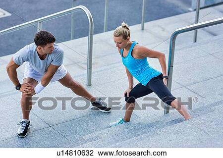 Young attractive couple exercising in stairs View Large Photo Image Stock Image - Young attractive couple exercising in stairs. Fotosearch