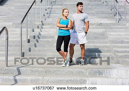 Stock Photo - Young attractive couple exercising in stairs. Fotosearch