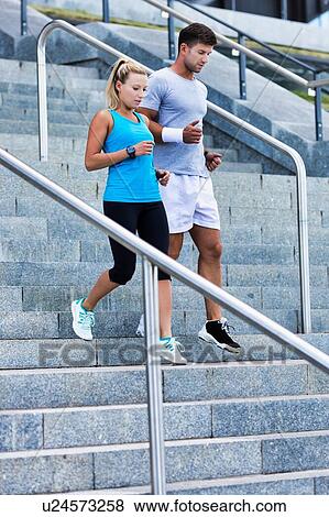 Stock Photo - Young attractive couple exercising in stairs. Fotosearch