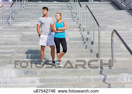 Stock Photograph - Young attractive couple exercising in stairs. Fotosearch