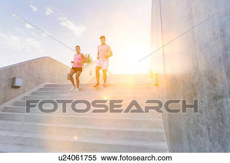 Young attractive couple exercising in stairs View Large Photo Image Stock Photography - Young attractive couple exercising in stairs. Fotosearch