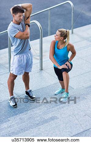 Stock Photography - Young attractive couple exercising in stairs. Fotosearch