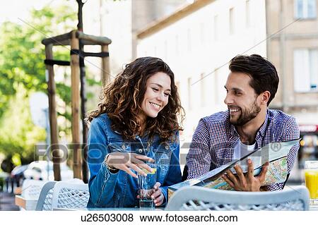 Young attractive couple smiling while looking at the menu in restaurant View Large Photo Image Stock Photo - Young attractive couple smiling while looking at the menu in restaurant . Fotosearch