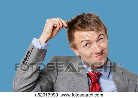 Stock Image - Young businessman pulling hair out. Fotosearch
