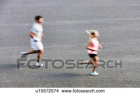 Picture - Young couple excersising in park. Fotosearch