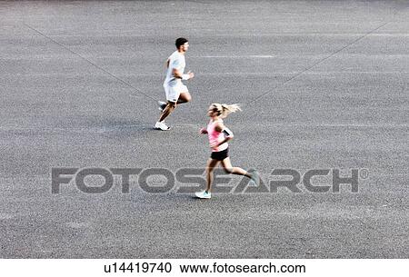 Stock Image - Young couple excersising in park. Fotosearch