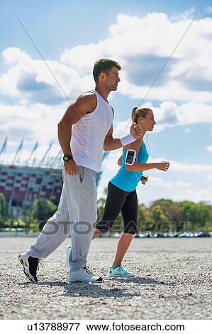 Stock Photo - Young couple excersising in park. Fotosearch