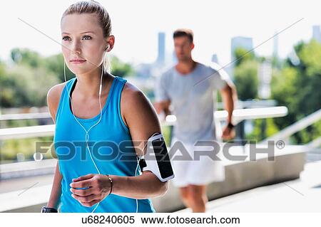 Stock Photography - Young couple excersising in park. Fotosearch