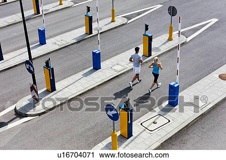 Young couple excersising in the middle of the city View Large Photo Image Stock Image - Young couple excersising in the middle of the city. Fotosearch
