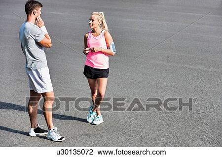 Young couple excersising in the middle of the city View Large Photo Image Stock Image - Young couple excersising in the middle of the city. Fotosearch