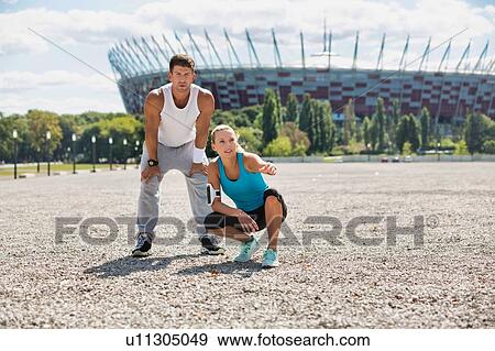 Stock Photo - Young couple excersising in the middle of the city. Fotosearch