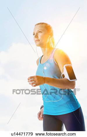 Stock Photo - Young couple excersising in the middle of the city. Fotosearch