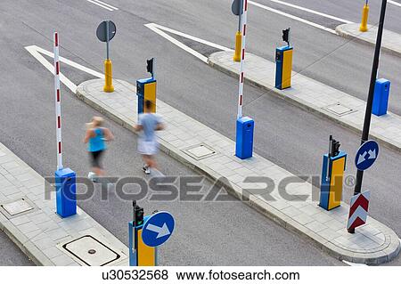 Stock Photo - Young couple excersising in the middle of the city. Fotosearch