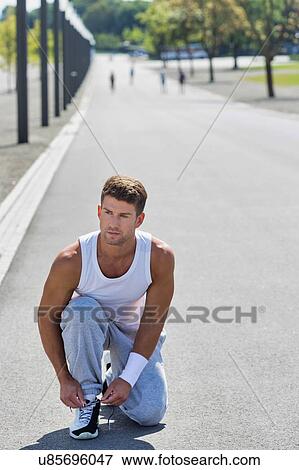 Stock Photo - Young couple excersising in the middle of the city. Fotosearch