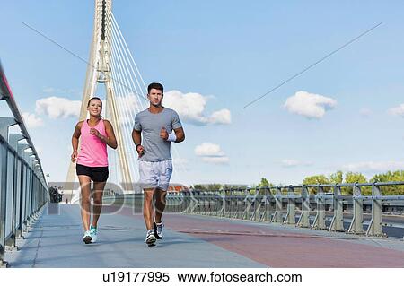 Stock Photography - Young couple excersising in the middle of the city. Fotosearch