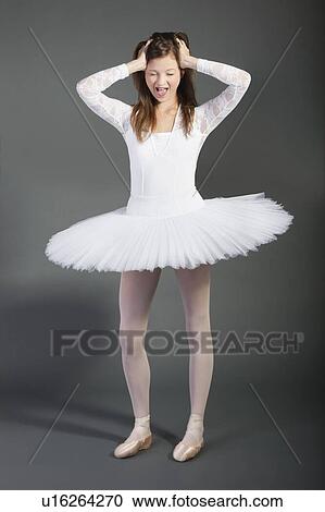 Young female ballet dancer screaming over grey background View Large Photo Image Stock Image - Young female ballet dancer screaming over grey background. Fotosearch