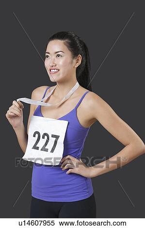Young female medalist looking up against black background View Large Photo Image Stock Photography - Young female medalist looking up against black background. Fotosearch