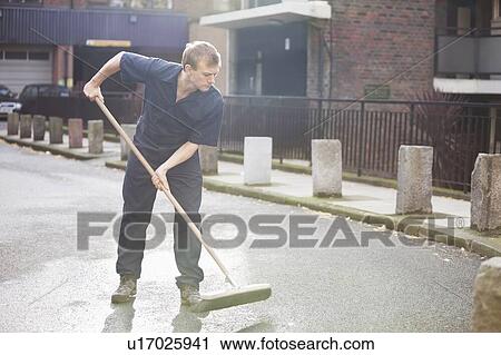 Stock Image - Young male street sweeper. Fotosearch