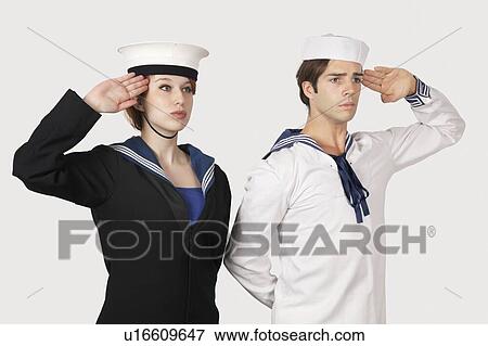 Young man and woman in sailor's uniform saluting against gray background View Large Photo Image Stock Photo - Young man and woman in sailor's uniform saluting against gray background. Fotosearch