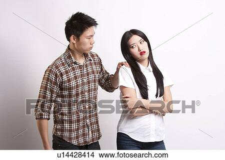 Young man convincing beautiful woman over white background View Large Photo Image Picture - Young man convincing beautiful woman over white background. Fotosearch
