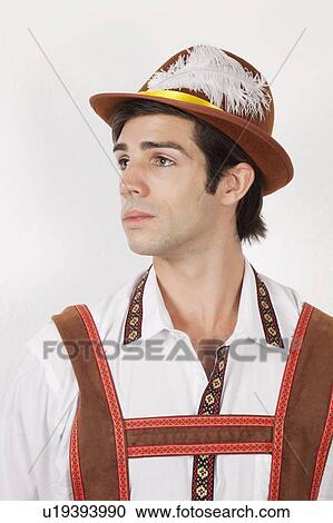 Young man in costume looking away against gray background View Large Photo Image Stock Image - Young man in costume looking away against gray background. Fotosearch