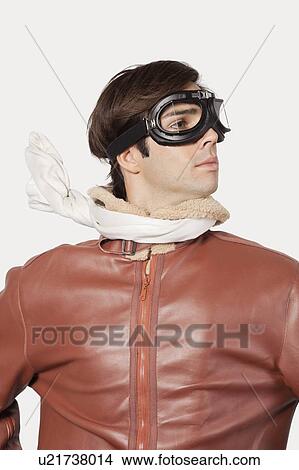 Young man in old-fashioned pilot costume over gray background View Large Photo Image Picture - Young man in old-fashioned pilot costume over gray background. Fotosearch