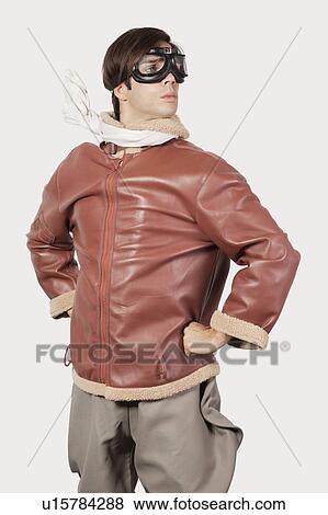 Stock Photo - Young man in old-fashioned pilot costume against gray background. Fotosearch