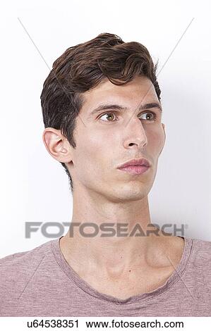 Young man looking away against white background View Large Photo Image Stock Image - Young man looking away against white background. Fotosearch