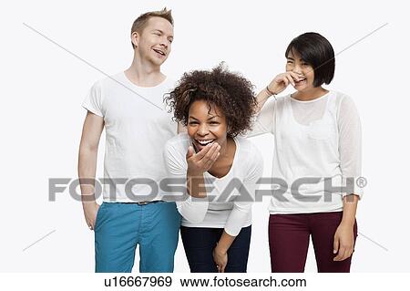 Young multi-ethnic friends in casuals laughing over white background View Large Photo Image Stock Photo - Young multi-ethnic friends in casuals laughing over white background. Fotosearch