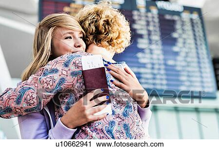 Young teenage girl reuniting with her mother in airport View Large Photo Image Stock Image - Young teenage girl reuniting with her mother in airport. Fotosearch