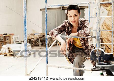 Stock Image - Young Woman artist in her creative studio. Fotosearch