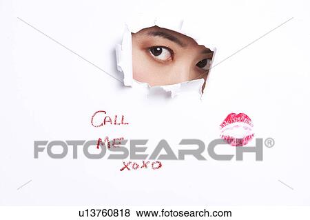 Young woman peeking through ripped paper with text message and lipstick mark View Large Photo Image Stock Photo - Young woman peeking through ripped paper with text message and lipstick mark. Fotosearch