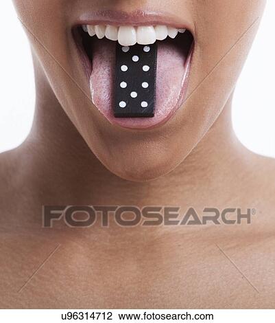 Young woman with domino on tongue against white background View Large Photo Image Stock Image - Young woman with domino on tongue against white background. Fotosearch