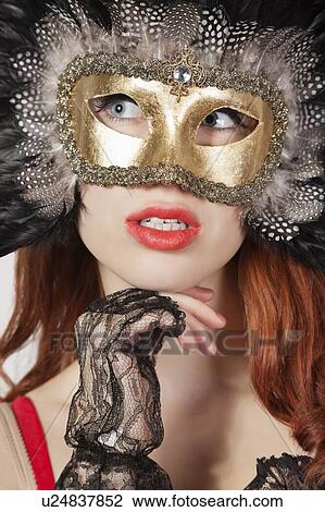 Young woman with feathered eye mask looking away View Large Photo Image Stock Image - Young woman with feathered eye mask looking away. Fotosearch