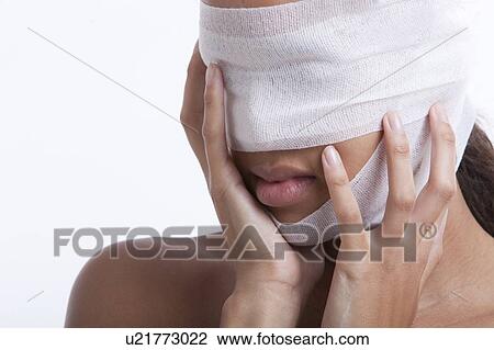 Young woman with head wrapped in bandage against white background View Large Photo Image Stock Image - Young woman with head wrapped in bandage against white background. Fotosearch
