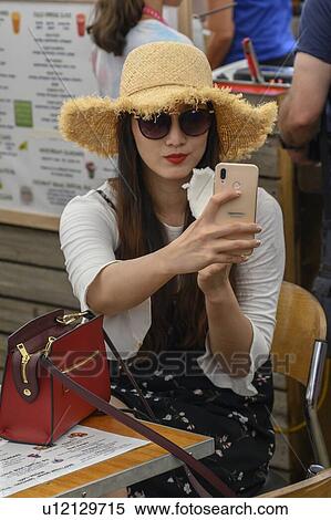 Woman sitting at caf� taking selfie, Kuranda, Queensland, Australia View Large Photo Image Stock Photography - Woman sitting at caf� taking selfie, Kuranda, Queensland, Australia. Fotosearch