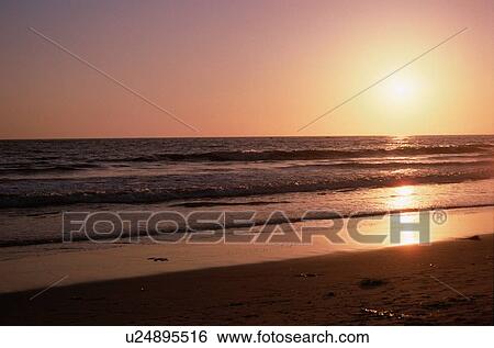 Stock Photograph - Setting Sun At Beach. Fotosearch