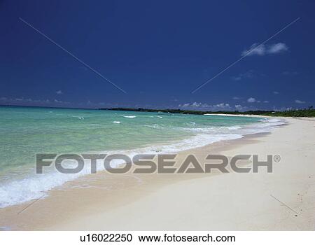 Stock Image - The Seashore And The Blue Sky Of White Sand. Fotosearch