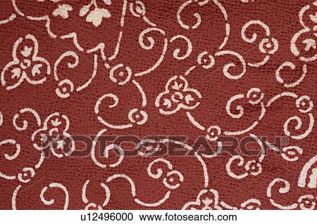 Stock Image - Foliate Patterns On Red Cloth. Fotosearch